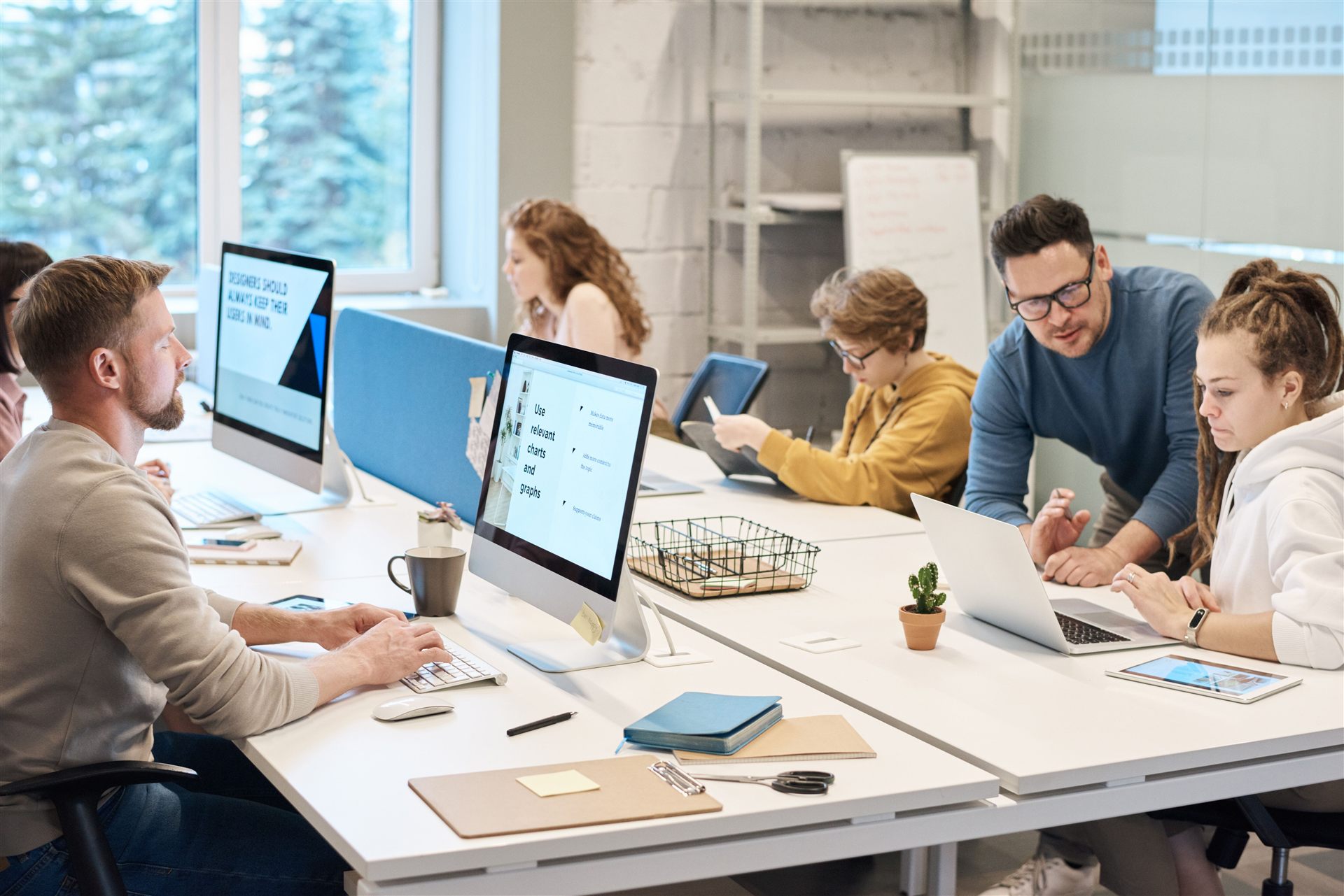Team collaborating at computers in a modern office